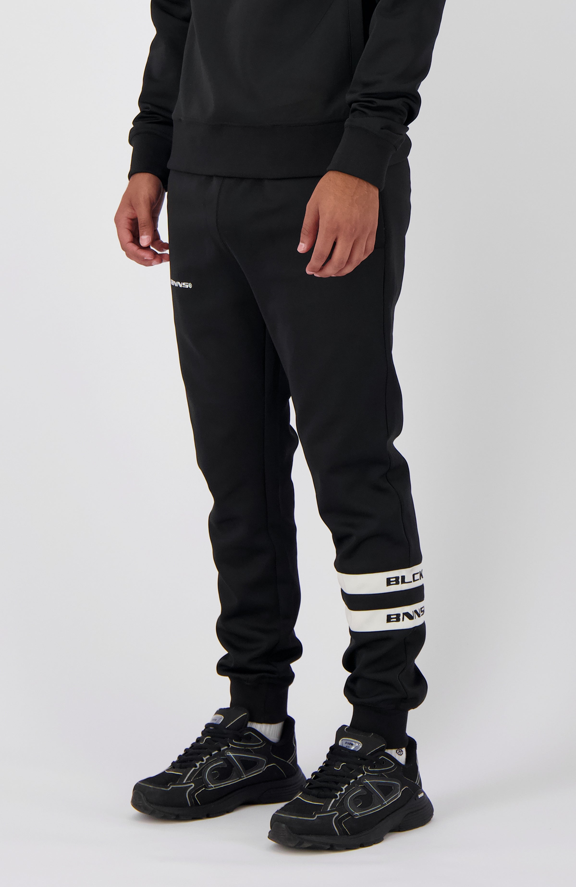 //blackbananas.com/cdn/shop/files/CHARGE_TRACKPANTS_1.224.4.23-000000-02_{width}x.jpg?v=1723194136